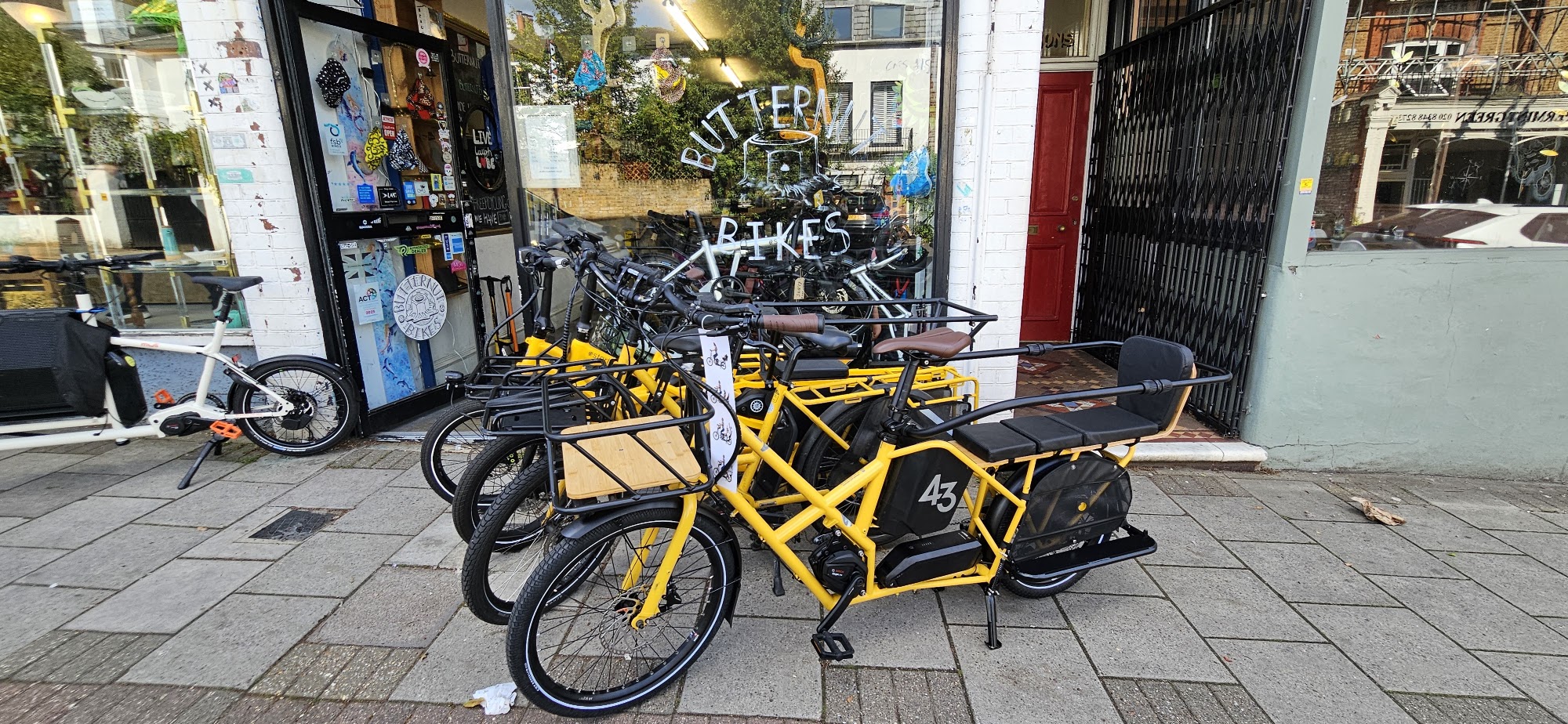 Yellow Bike43, Tern GSD and Estarli cargo bikes lined up outside the Butternut Bikes shopfront in Crouch End