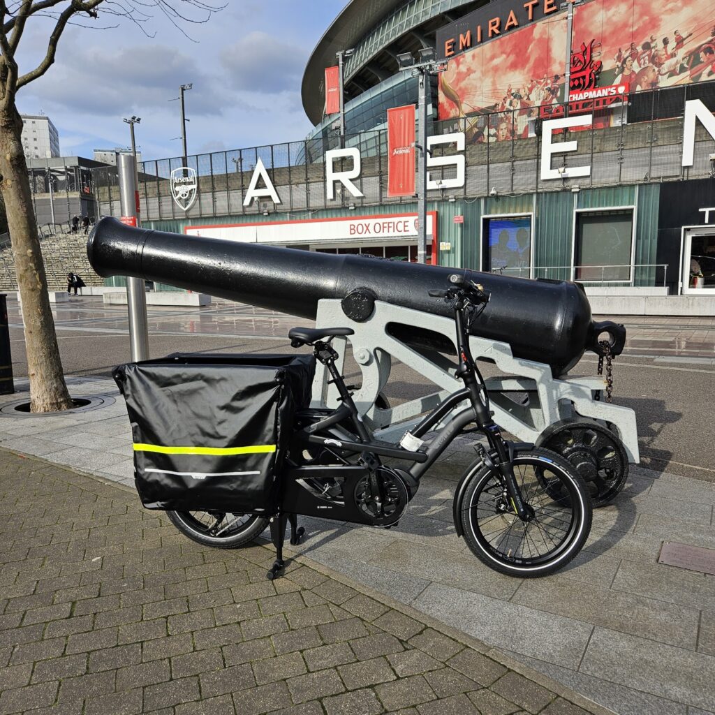 Black Tern GSD electric cargo bike beside the cannon outside the Emirates Stadium in north London