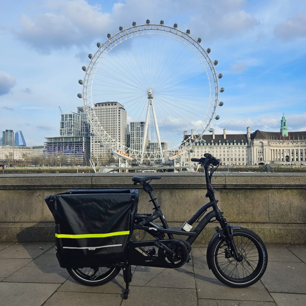 Black Tern GSD electric cargo bike parked on the South Bank with the London Eye behind