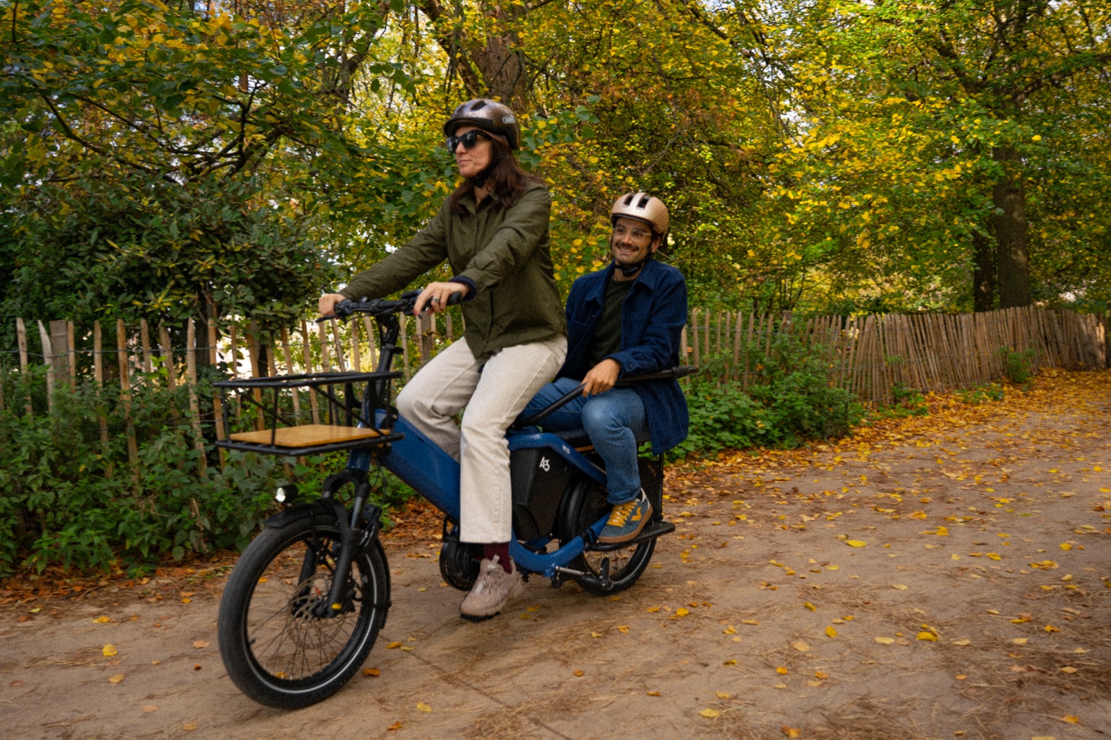 Bike43 Mid in blue carrying an adult passenger on the back