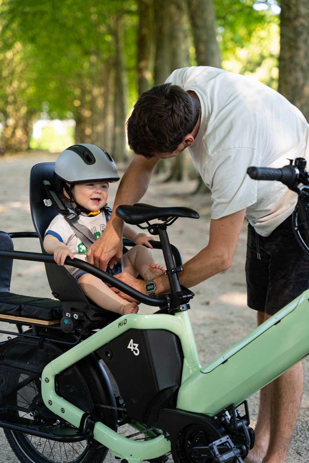 Strapping a baby into the rear child seat on a Bike43