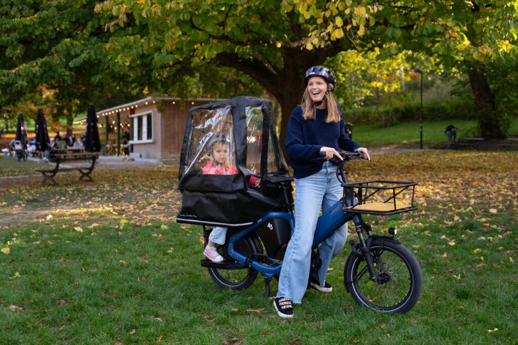 A child zipped inside the Bike43 Rain Canopy on a Bike43 Mid
