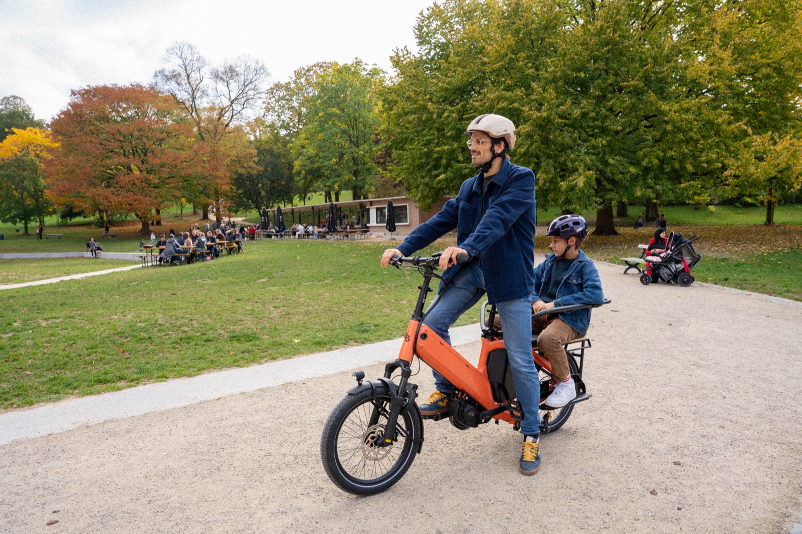 Bike43 Short in orange riding through a park with a child on the back