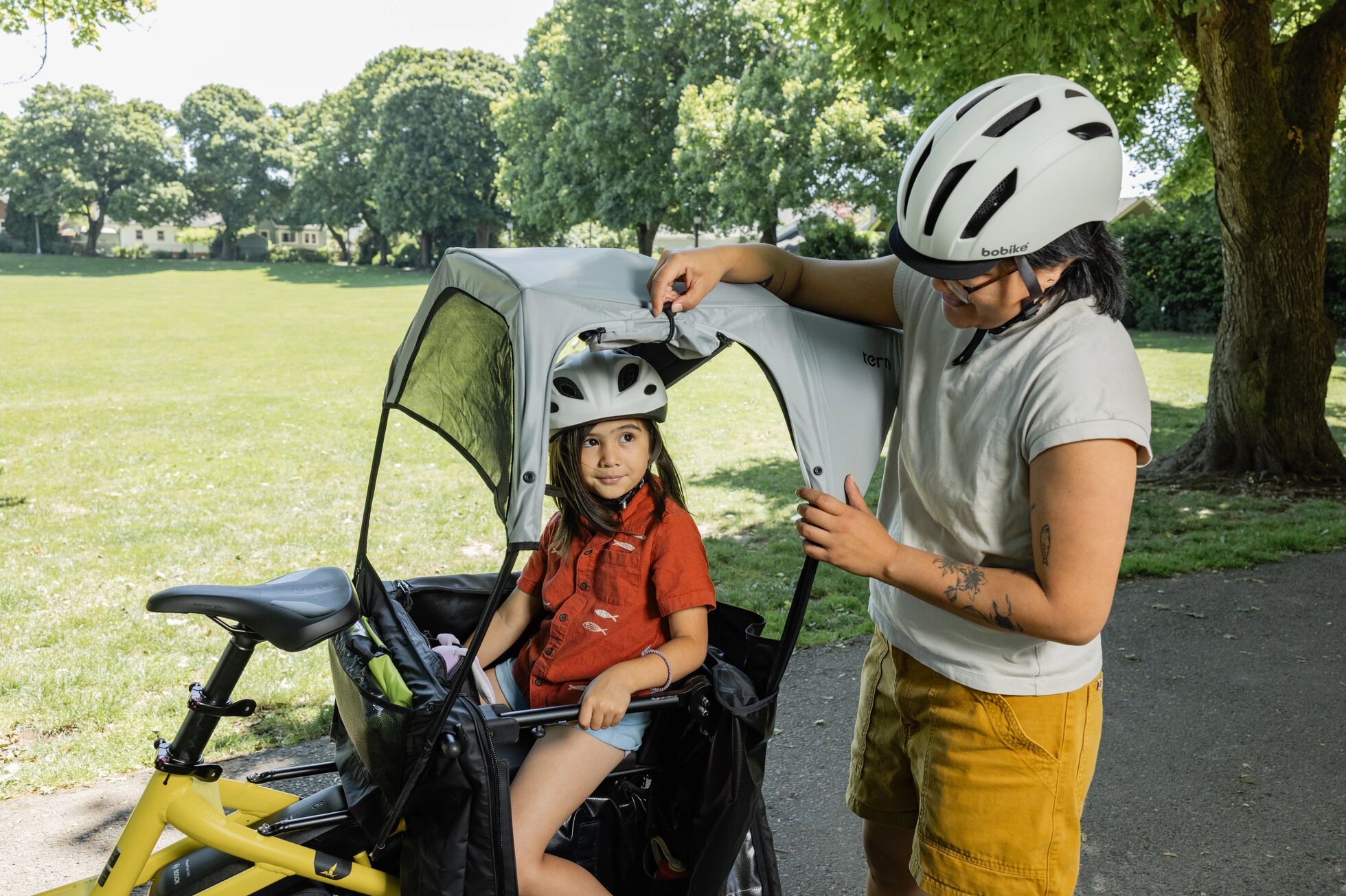 Child riding under the Tern Sun Shield Mini on a Tern HSD